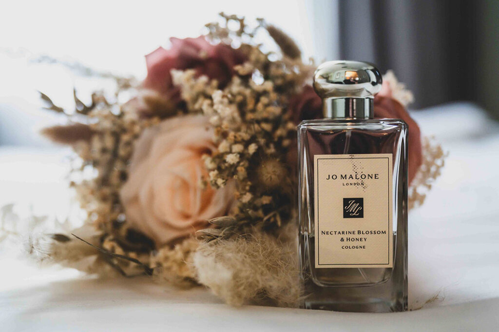 Jo Malone perfume and floral bouquet captured by a North East photographer in a soft, elegant detail shot”