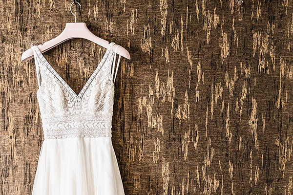 Lace‑detailed bridal gown displayed on a hanger before a North East wedding