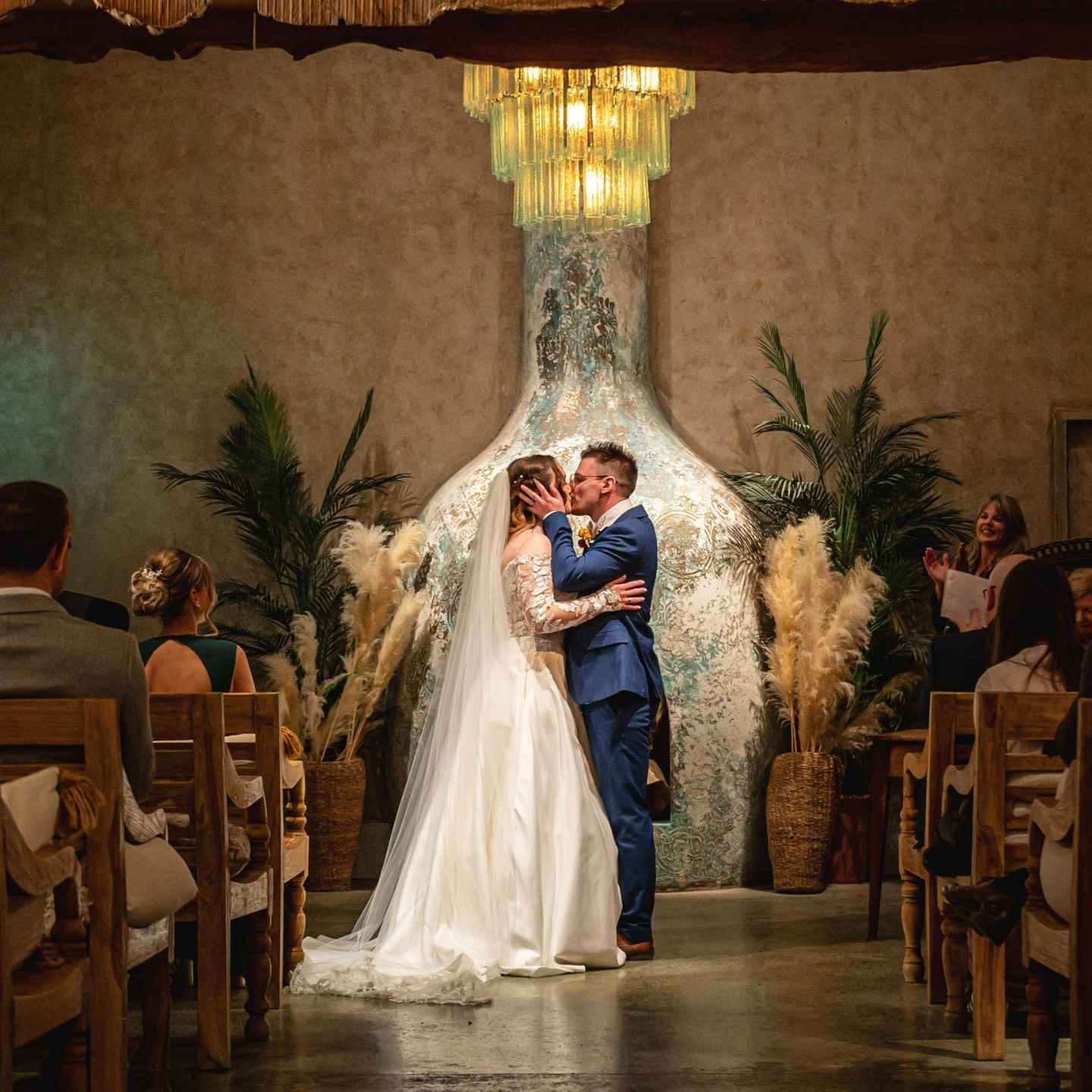 A just‑married couple stand together inside the chapel at Runa Farm in Barnard Castle, captured by Tees Valley Weddings. Warm natural light highlights the rustic wooden interior as they celebrate their wedding ceremony.